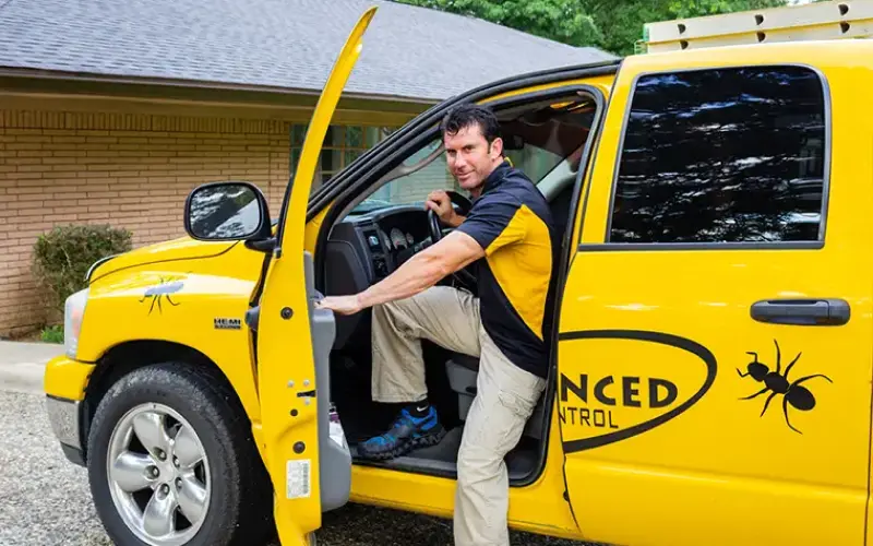 An Advanced Pest Control technician exits a service truck before implementing Pest Control and Exterminator services in Hot Springs.